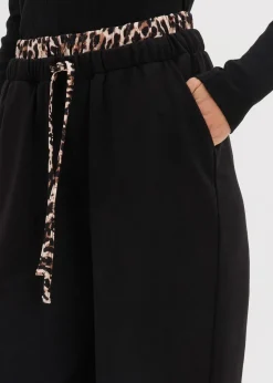 bonprix Bekleidung·Blusen & Tuniken|Bekleidung·Kleider^Weite Sweathose mit Kontrastbund schwarz leo bedruckt